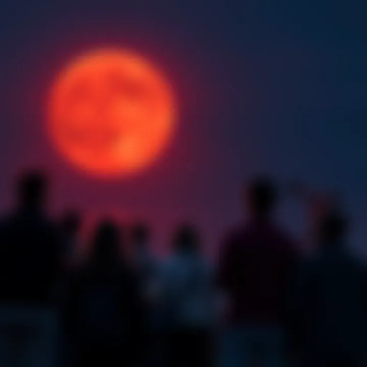 People watching the Blood Moon A group of people gathered outdoors, gazing up at a bright Blood Moon in the night sky, some holding telescopes and snacks.