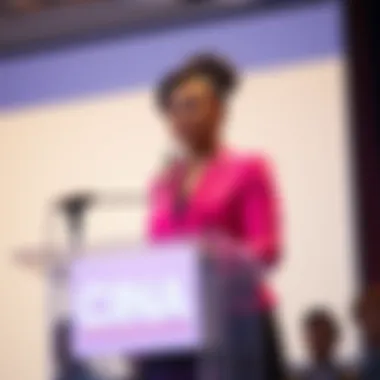 Cinna speaks at a podium addressing concerns about Bonnie's verbal mistake