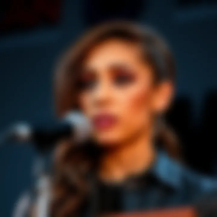 Cinna expresses her thoughts on the backlash regarding her comments about ICE after a Minnesota shooting, standing at a microphone with a thoughtful expression.