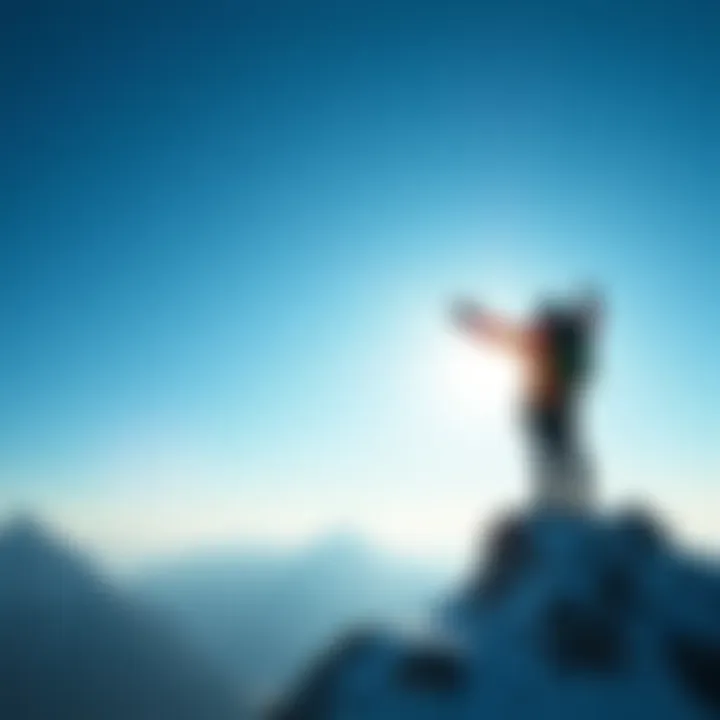 A climber celebrating at the peak of a mountain, arms raised in triumph against a clear blue sky.