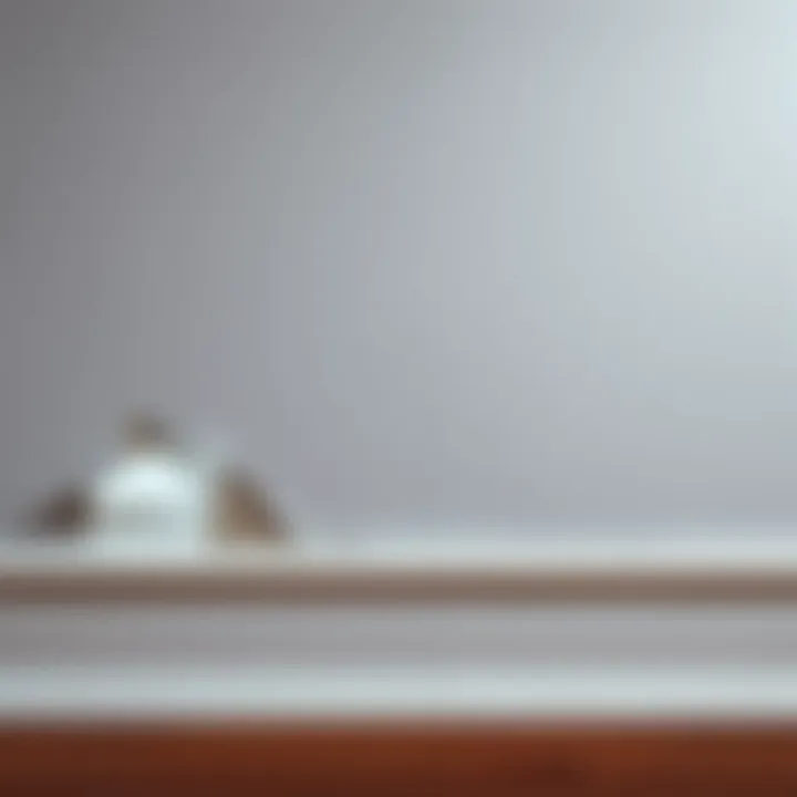 Close-up of a wall and baseboard damaged by a fallen Displate frame, showing peeling paint and scuffs