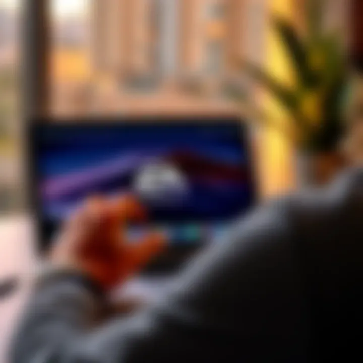 A person downloading the EA app on a MacBook Air, showing the app logo on the screen