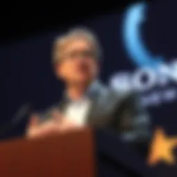 Former Sony CEO speaking at a conference A former Sony CEO discusses shorter game development times at a podium, emphasizing job preservation and creativity in the gaming industry.