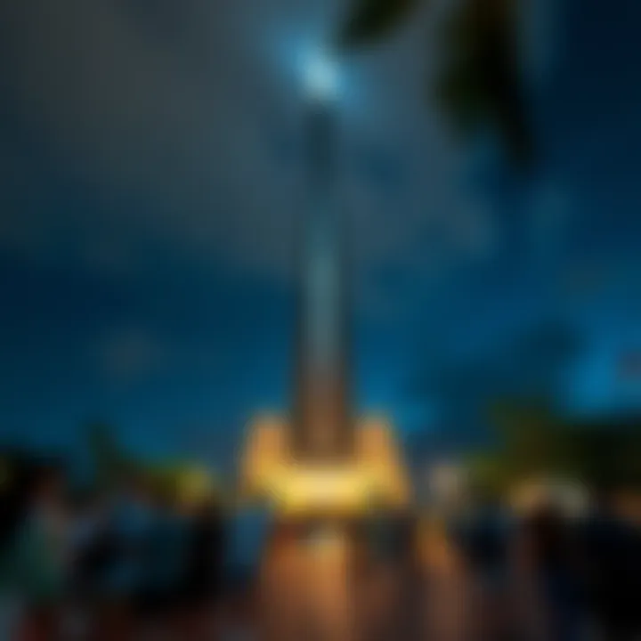 A Hawaiian tower illuminated at night with a crowd of visitors gathered around it