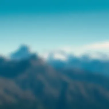 A breathtaking view of tall mountains with snow-capped peaks under a clear blue sky, showcasing the beauty of nature.