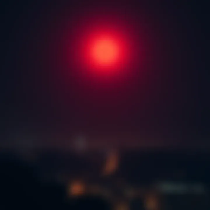 A bright red orb glowing in the dark sky over an urban landscape