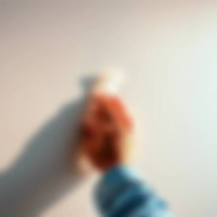 A person gently pulling an adhesive strip off a wall without leaving damage or residue