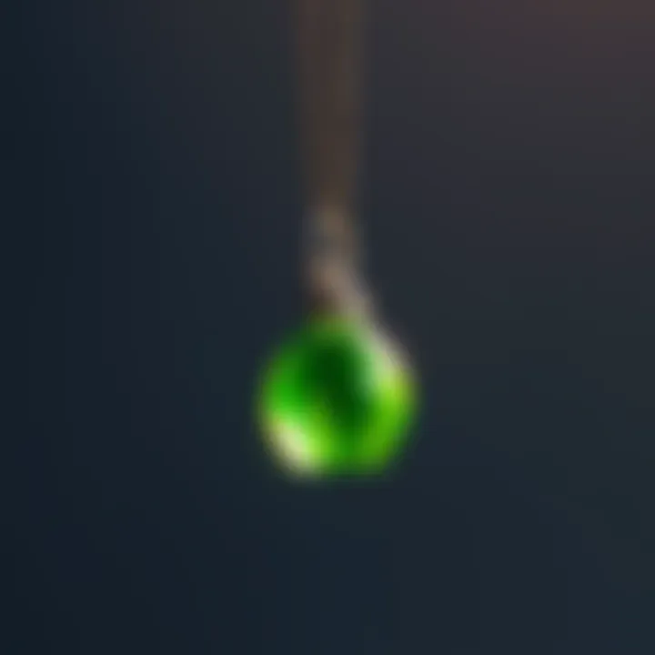 A close-up of a tiny green Sims Plumbob necklace hanging from a silver chain, showcasing its unique design and charm.