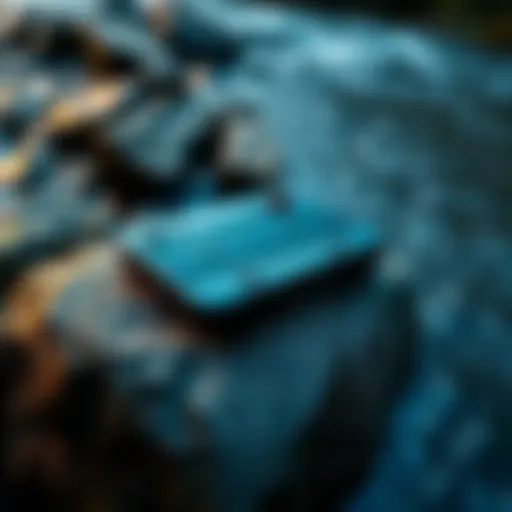 Steam Deck gaming device placed on a rock by a stream with water flowing nearby